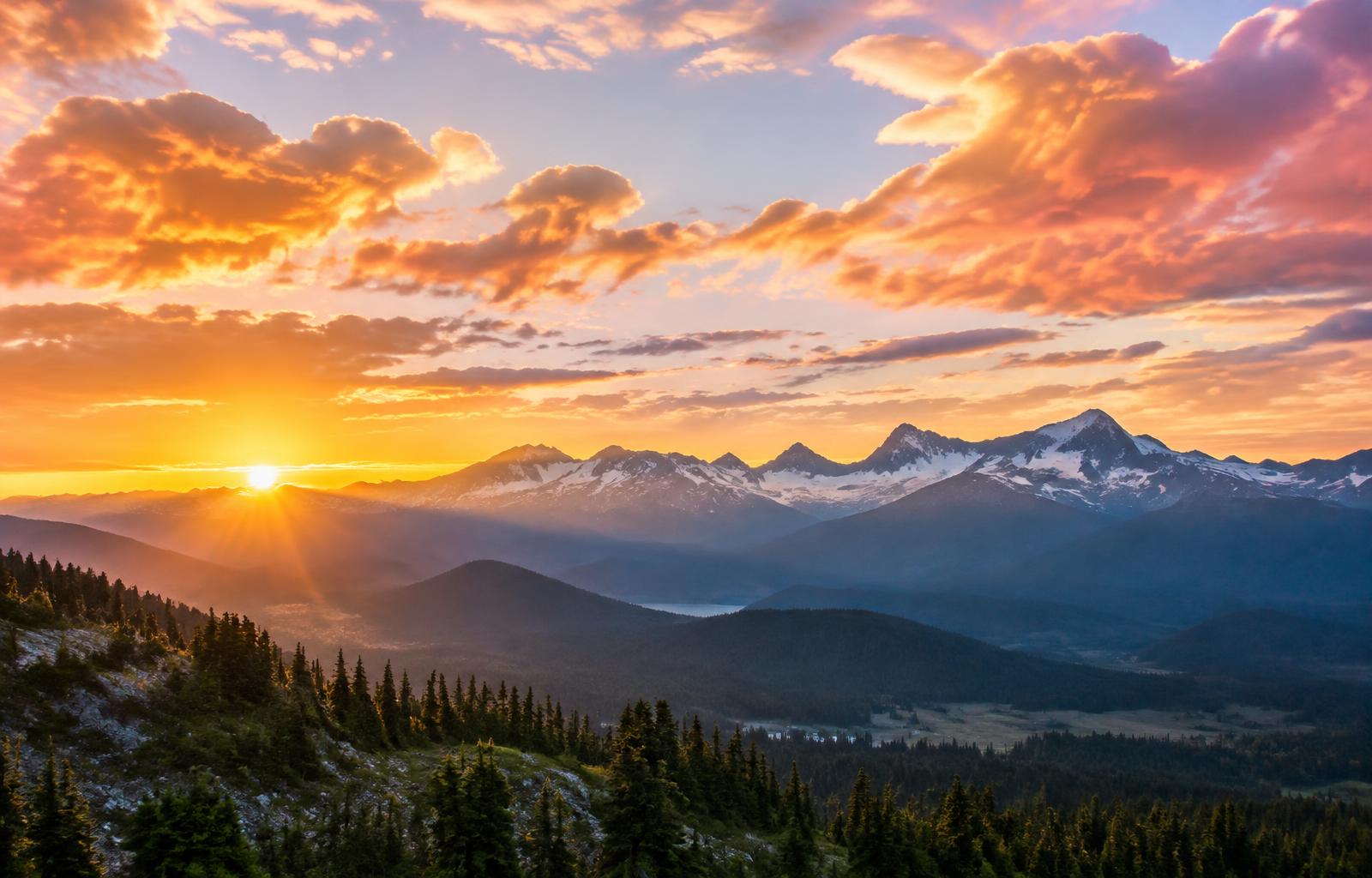 Sunrise breaking over the Rocky Mountains under big colorful clouds